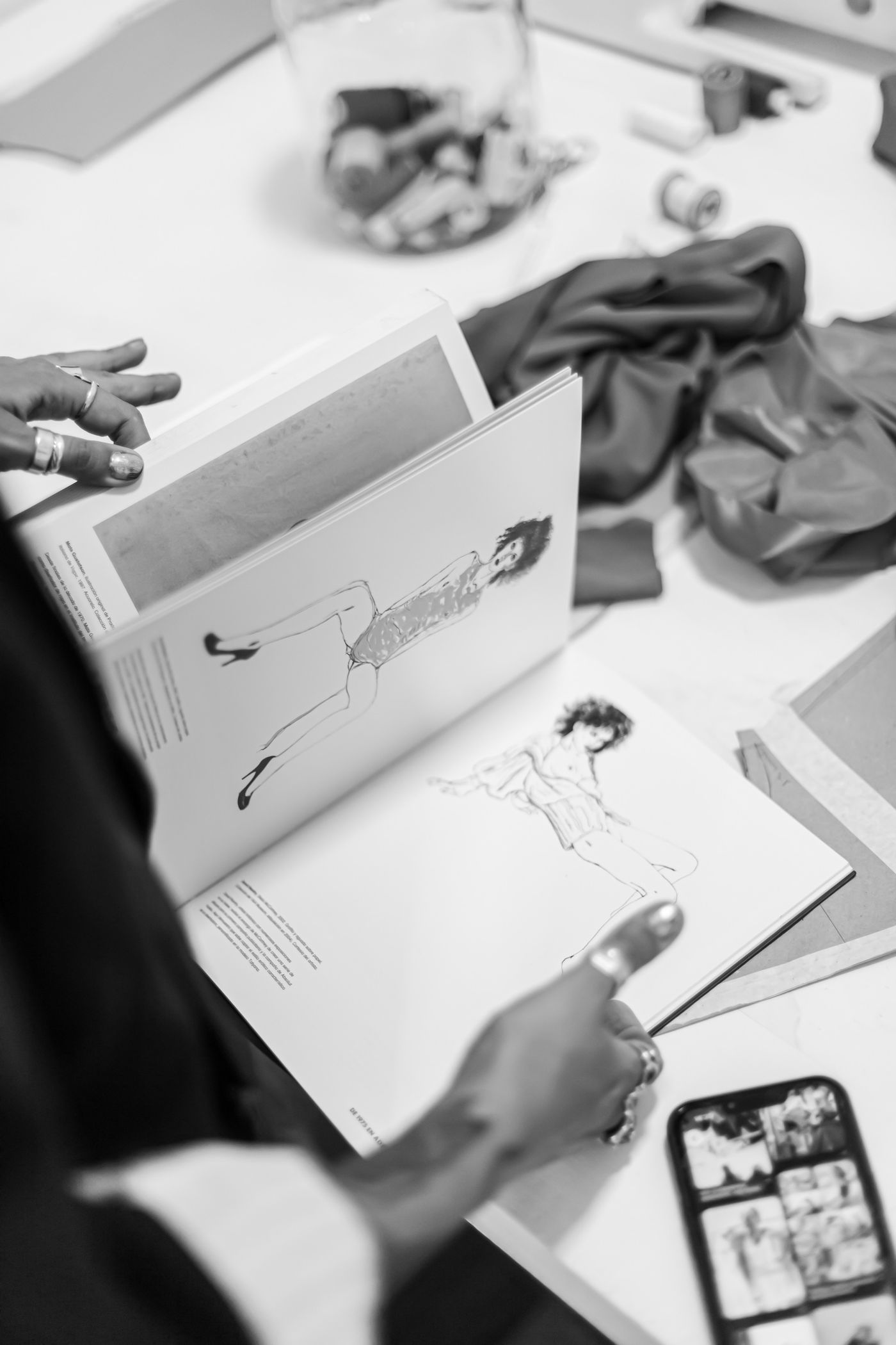 Fashion croquis and garment drawings in a sketchbook