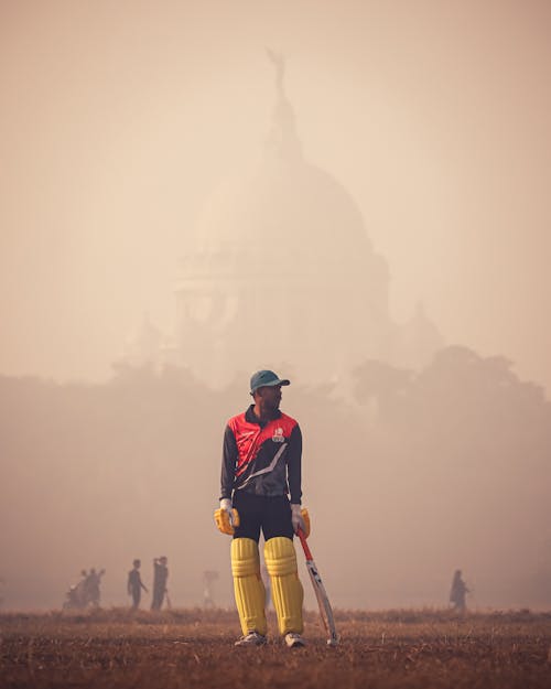 Cricketer in Sports Field with Dome of Victoria Memorial in Background