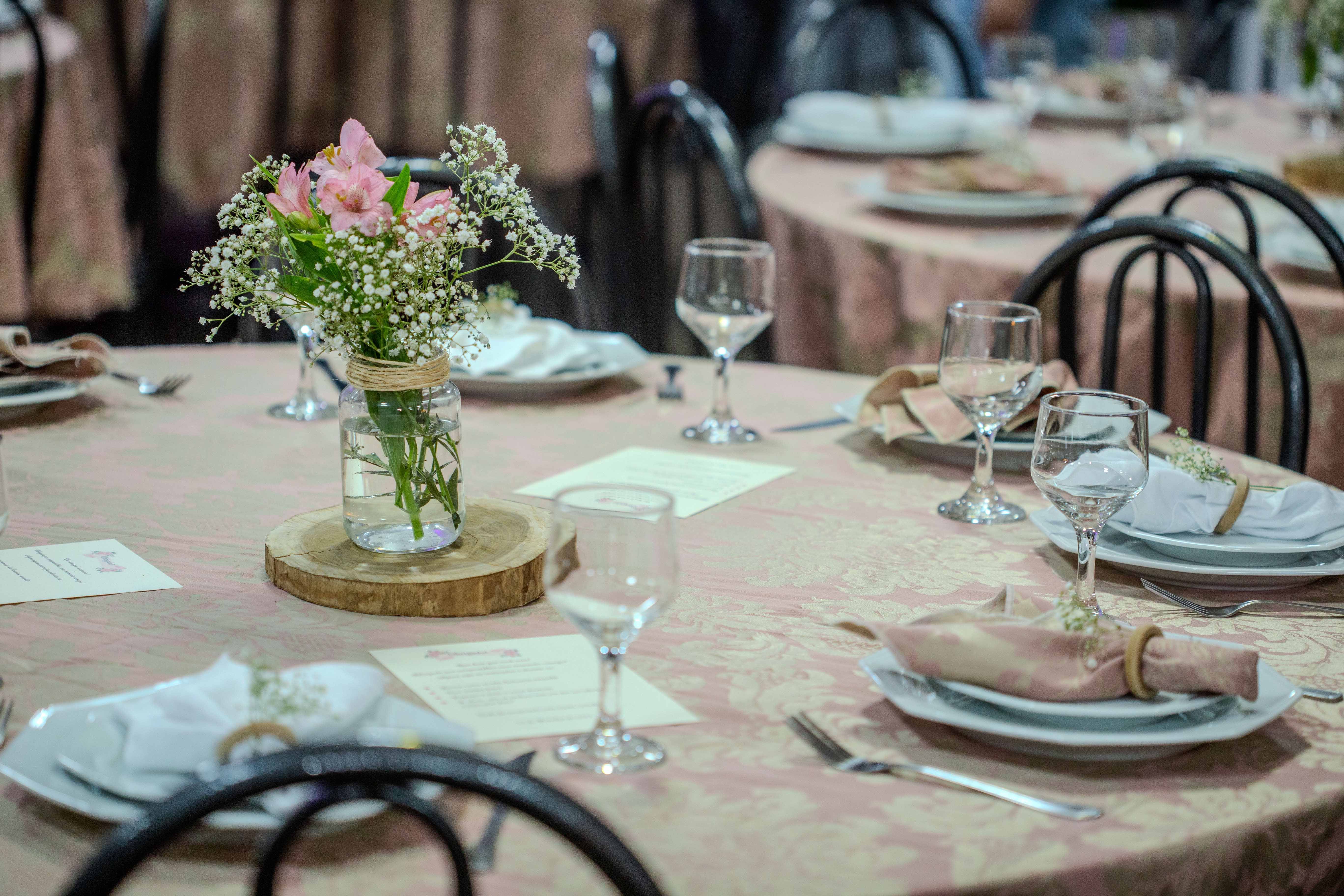 A beautifully arranged table with delicate floral centerpiece and elegant glassware, perfect for an upscale event.