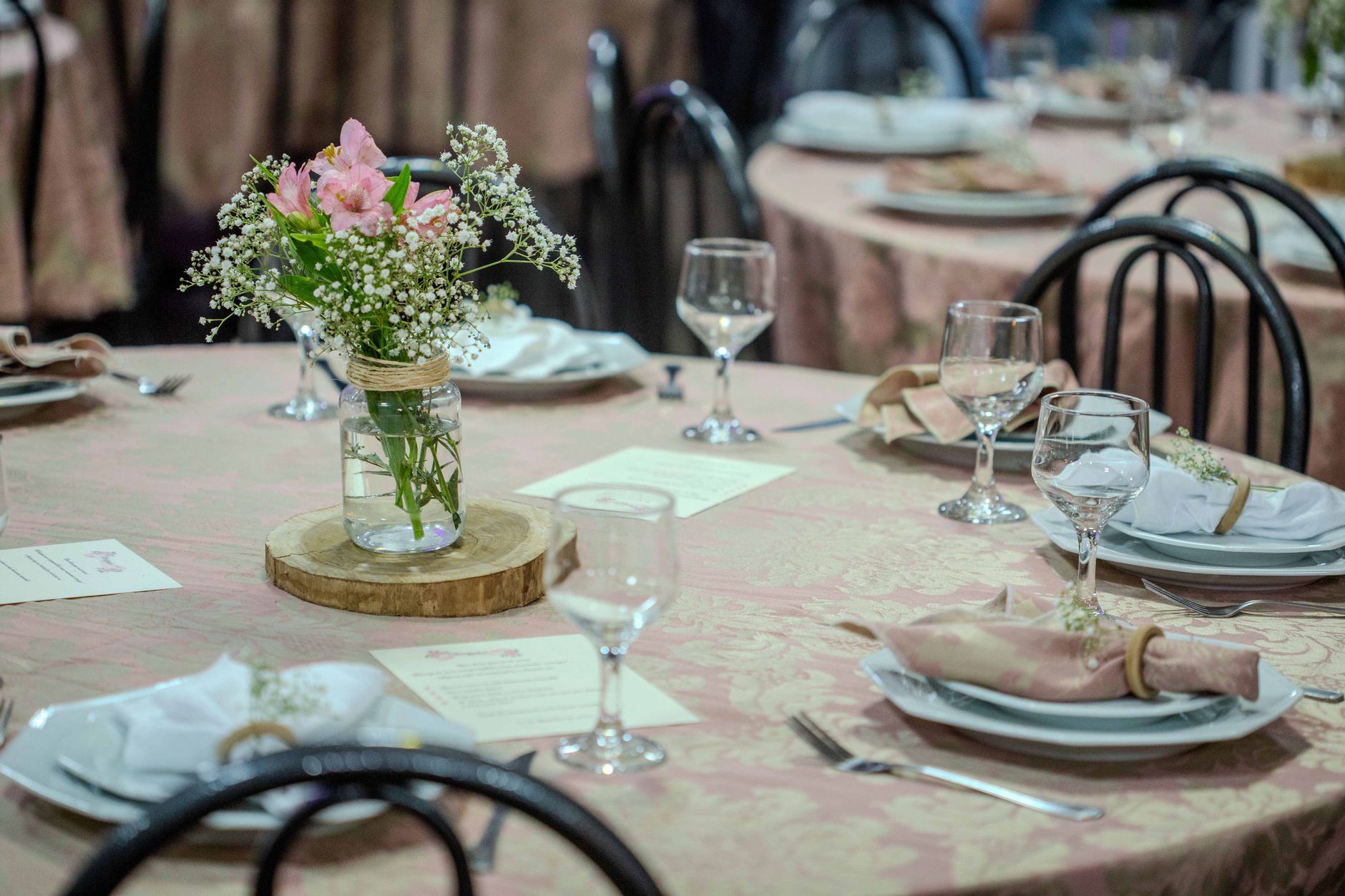 A beautifully arranged table with delicate floral centerpiece and elegant glassware, perfect for an upscale event.
