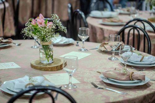 Free A beautifully arranged table with delicate floral centerpiece and elegant glassware, perfect for an upscale event. Stock Photo