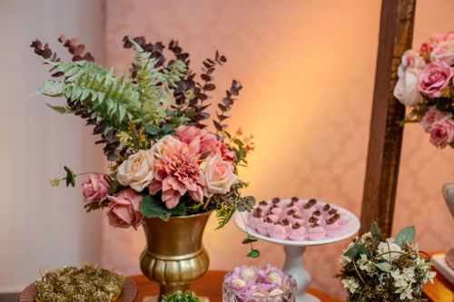 Free Beautiful floral arrangement with a variety of desserts, perfect for celebrations and gatherings. Stock Photo