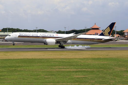 Singapore Airlines aircraft touchdown on runway, showcasing travel and aviation.