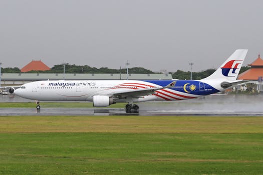 Malaysia Airlines Airbus A330 landing smoothly on a wet runway, showcasing travel and aviation.
