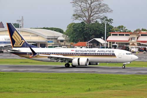 Free Singapore Airlines passenger jet taxiing on runway, ready for takeoff. Stock Photo