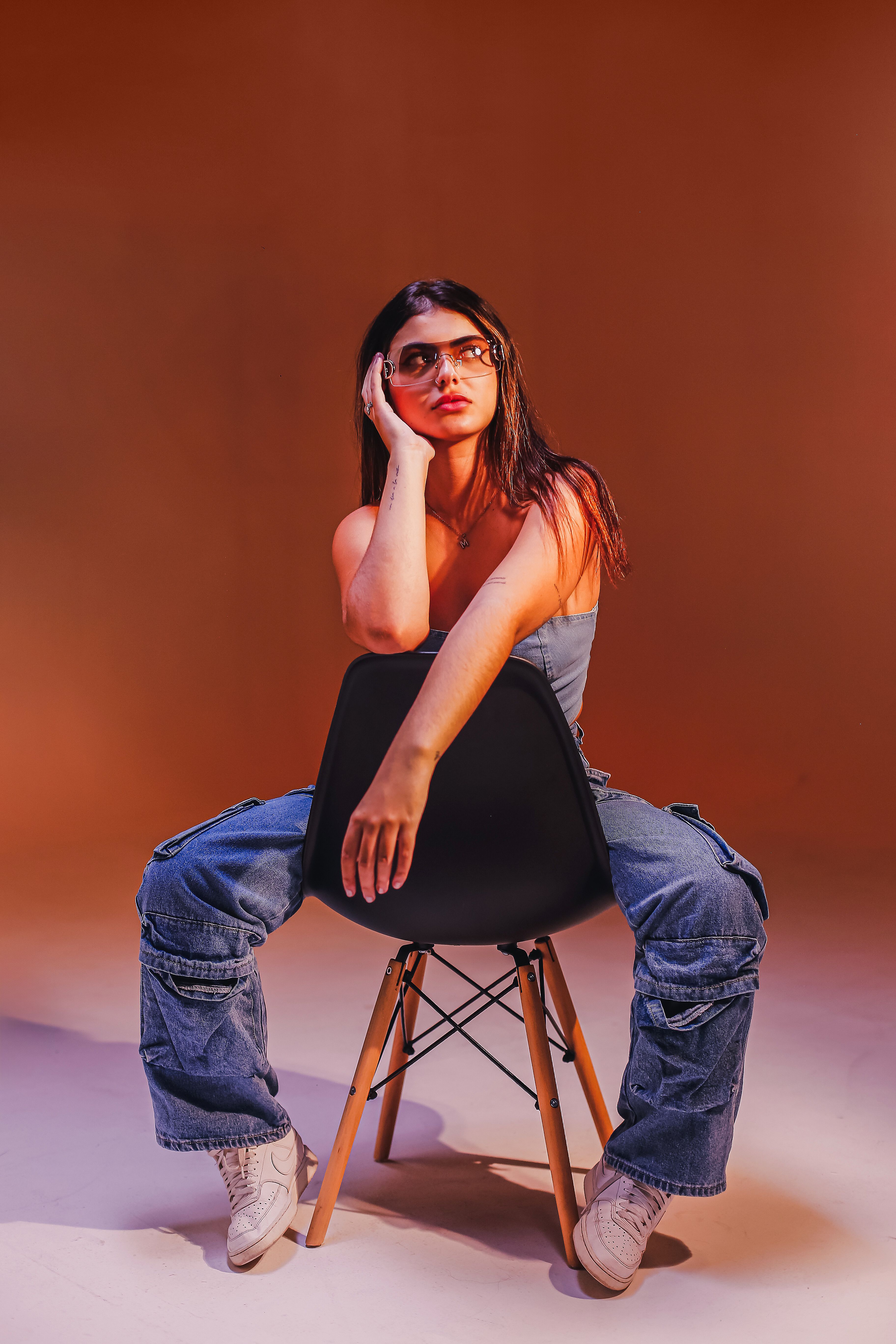 Sitting on Chair Woman in Jean Crop Top and Jeans · Free Stock Photo