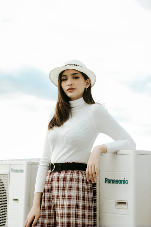 Woman in White Turtleneck Sweater and Check Pants