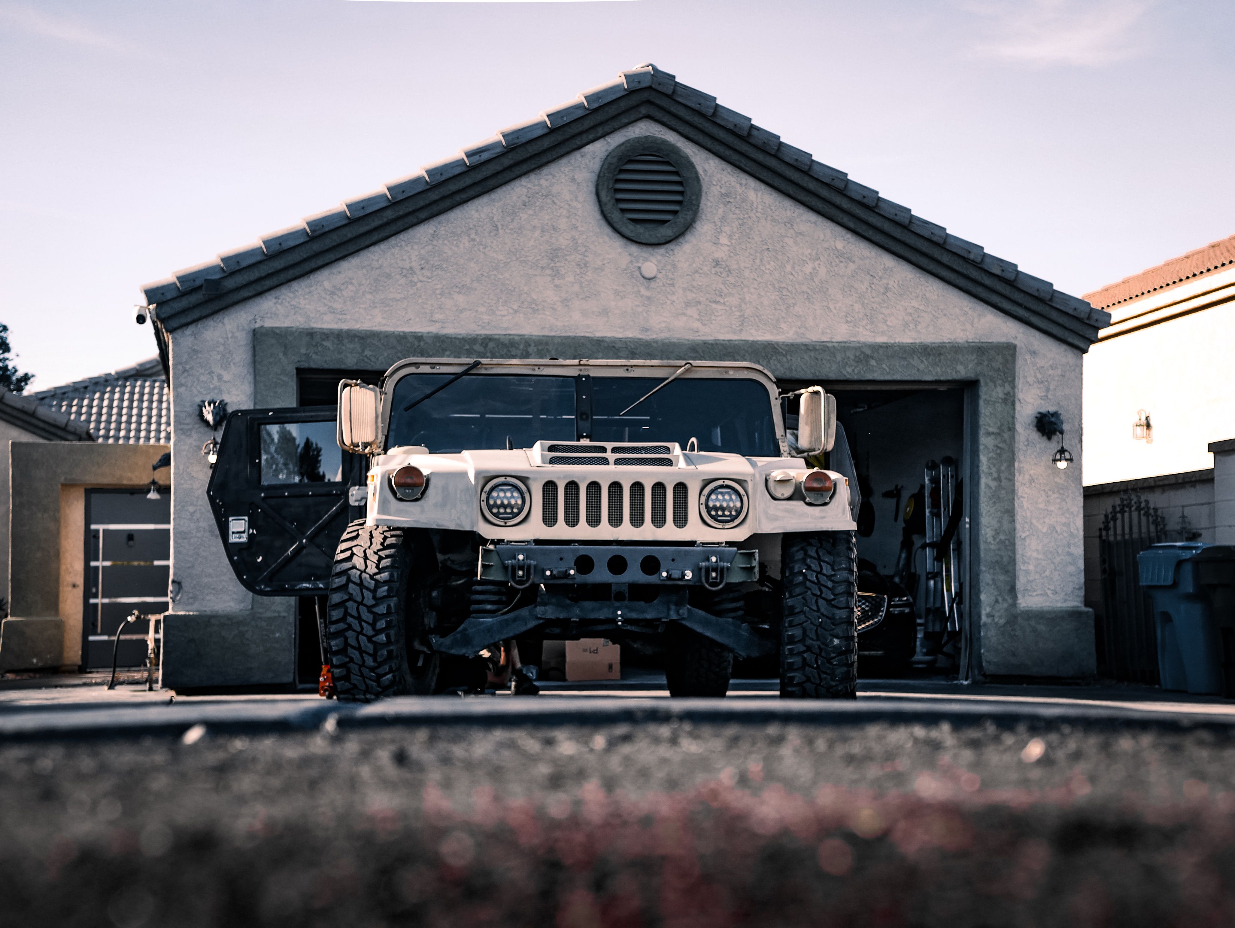 Heavy military vehicle in driveway showing need for 3/4 HP garage door opener