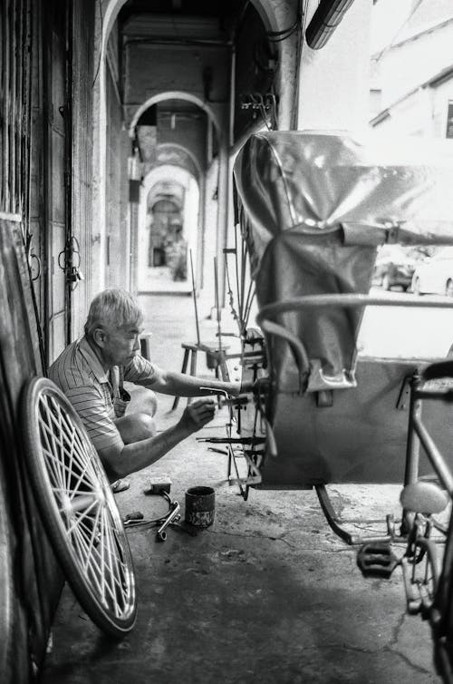 Man Repairing Rickshaw