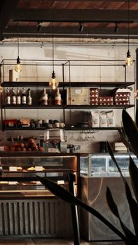 Warm café interior with modern shelving and ambient lighting. Ideal for design inspiration.