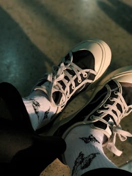Close-up of stylish black and white sneakers paired with pattern socks.