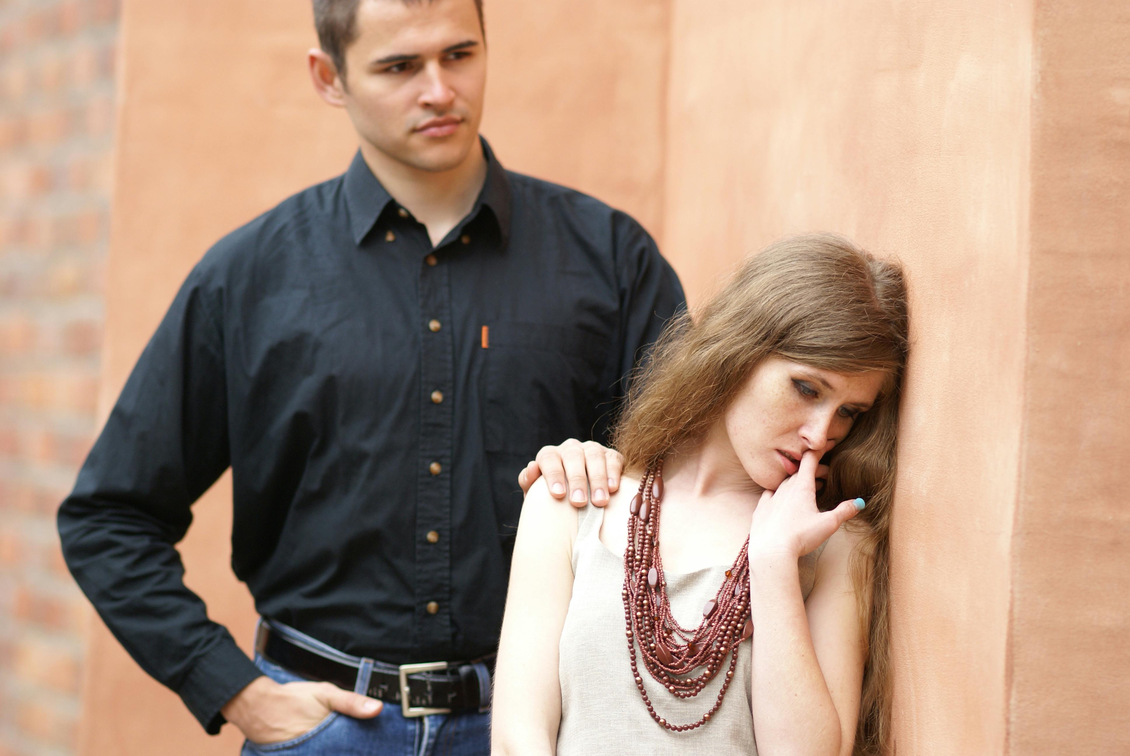 A thoughtful couple in a moment of intimacy and reflection indoors.