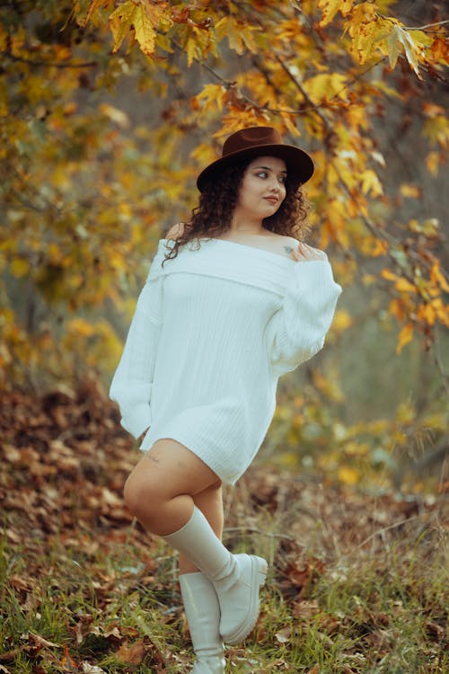 Female Model Wearing a White Sweater and a Fedora Posing Outdoors in Autumn