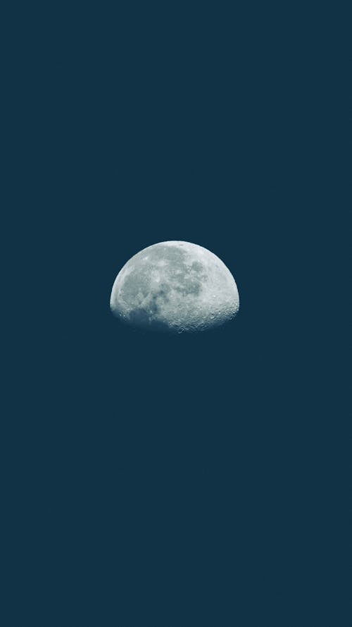 View of the Moon on the Background of Dark Blue Sky 