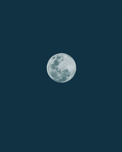 View of a Full Moon on the Background of Dark Blue Sky 