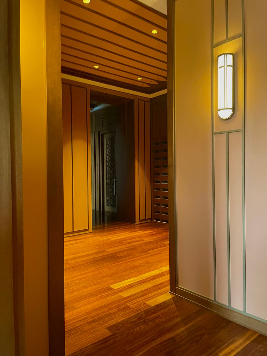 A warm timber-panelled corridor opening into a room - photo by Yunus Emre Ozcelik on Pexels