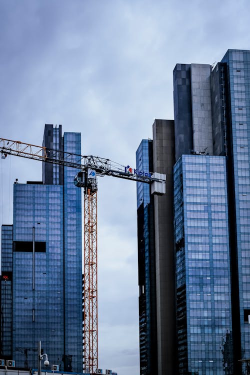 View of Modern Skyscrapers and a Crane in City 