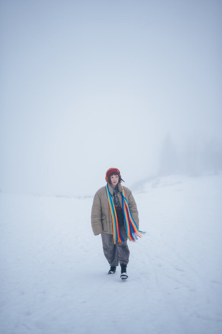 Woman Walking Through The Snow