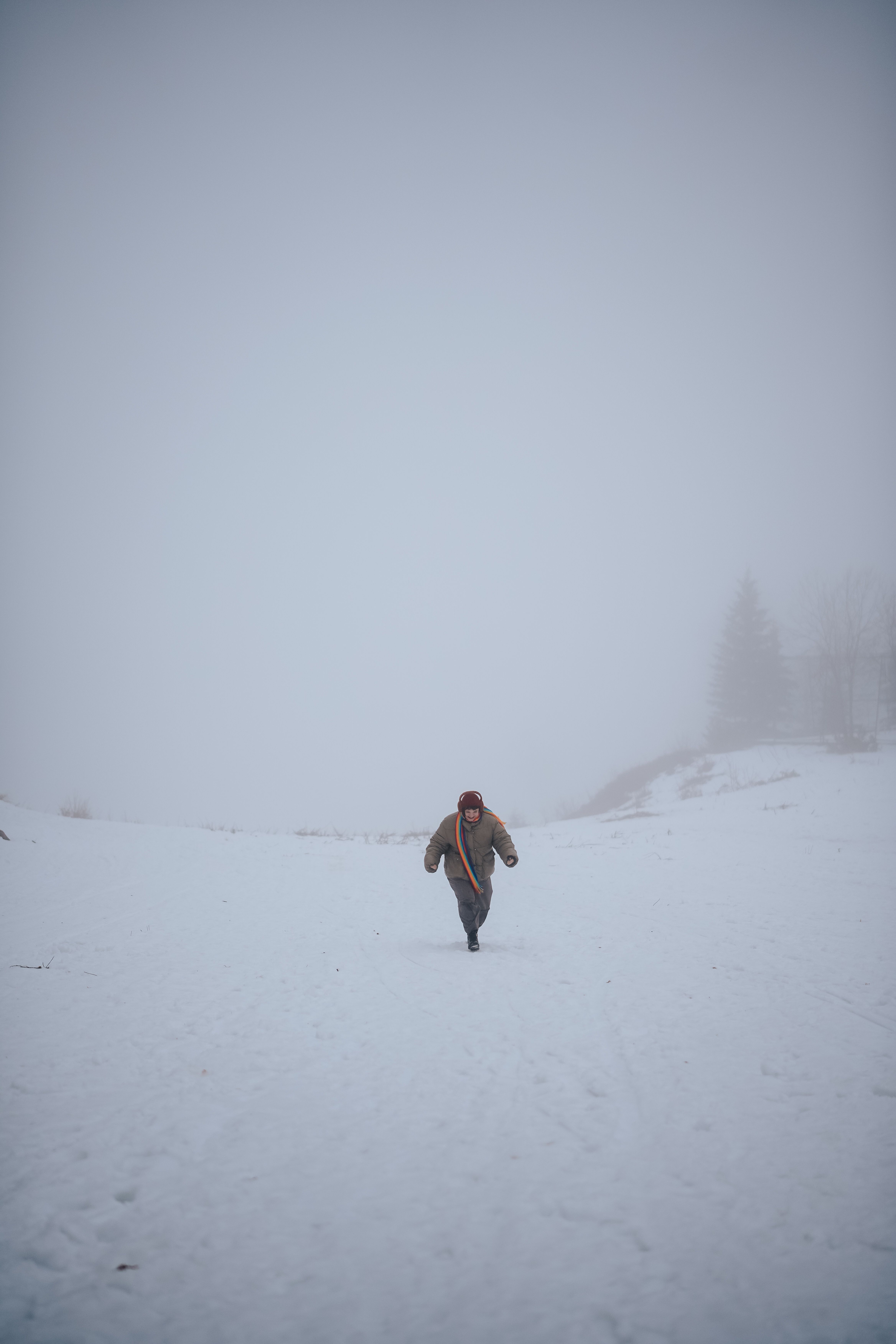 Person in Jacket Running in Snow · Free Stock Photo