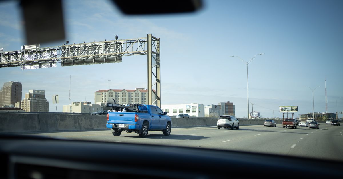 Shot of vehicles on a bustling city highway, capturing urban commute dynamics.
