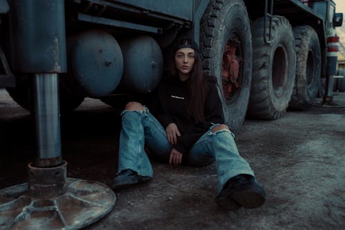 Woman Sitting Next to a Truck
