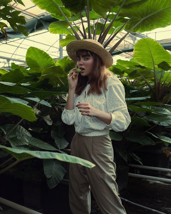 Woman Holding a Leaf by Her Mouth