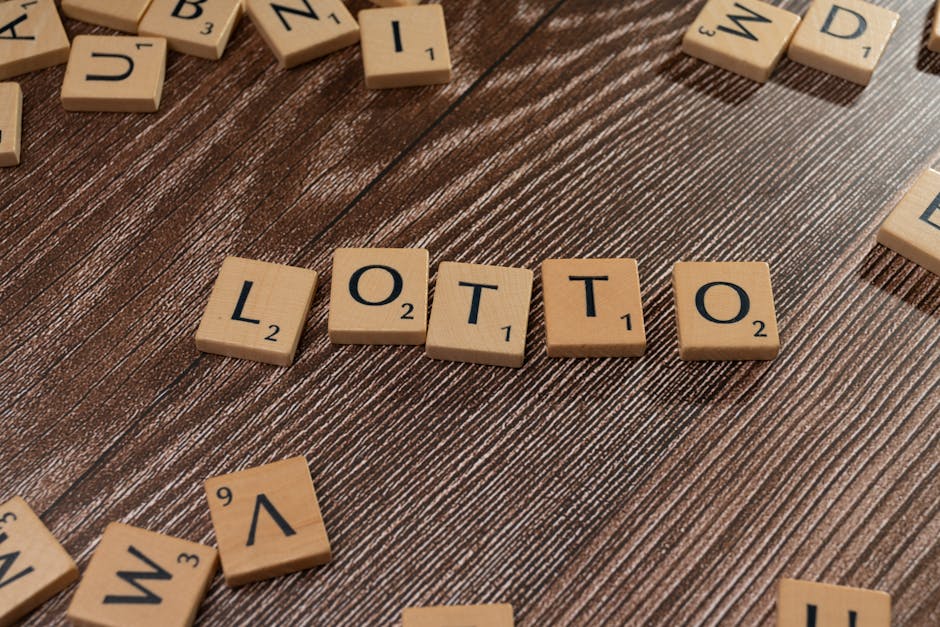 Scrabble tiles spelling 'LOTTO' on a wooden table surface, symbolizing chance and gaming.