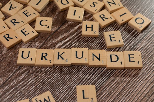 Wooden Scrabble tiles arranged on a textured surface forming words.