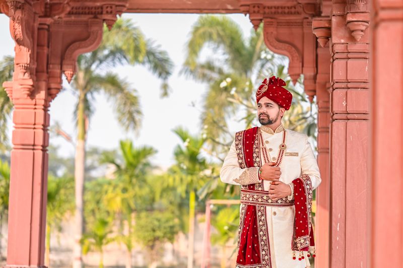 Groom in sherwani at a temple wedding celebration