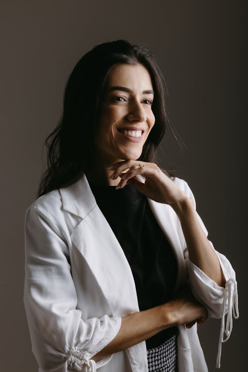 Portrait of Smiling Woman in White Suit