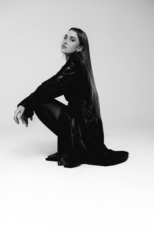 Woman in Dress Squatting in Black and White