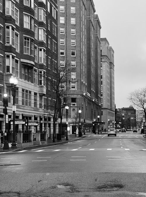 Free Black and white photo of a classic urban street with historic buildings. Stock Photo