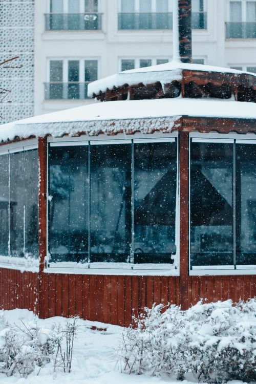Free A wooden gazebo covered in snow during a winter urban snowfall. Stock Photo