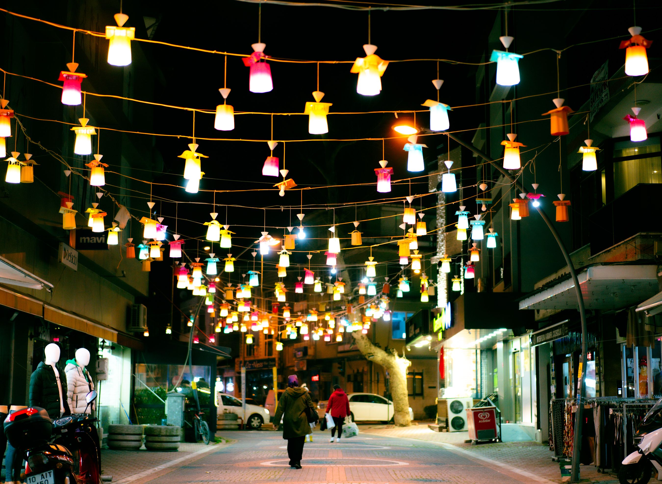 A street with lights hanging from the street lights · Free Stock Photo