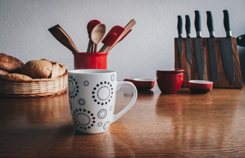 kitchen counter, bedroom dresser, or entry table at home coffee mug phone keys lifestyle photo 2