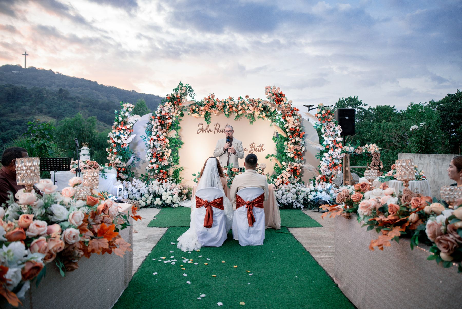 Newlyweds at a beautifully decorated outdoor wedding ceremony