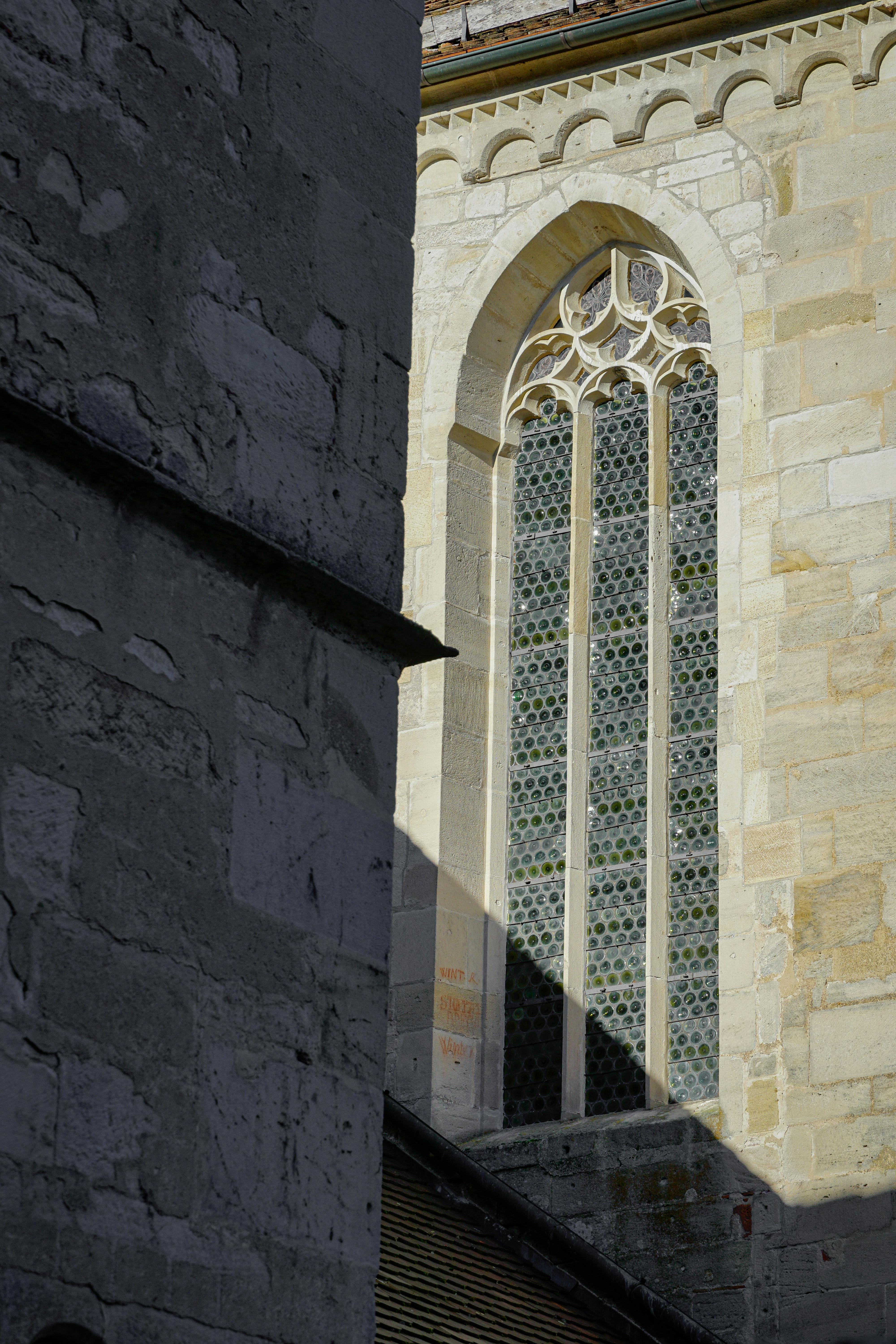Sunlit Gothic cathedral window highlighting intricate architectural design.
