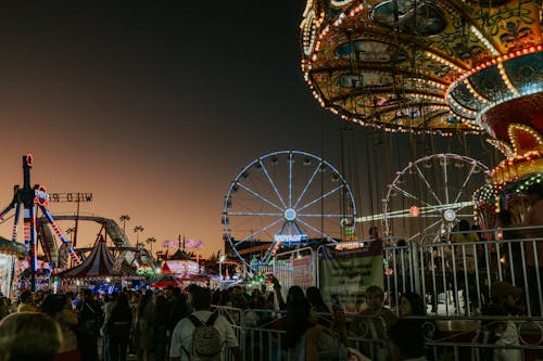 Crowd in Amusement Park at Dusk