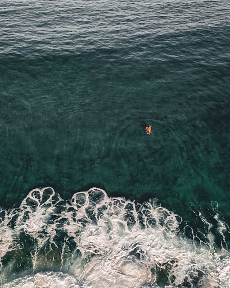 Person Swimming In Green Water