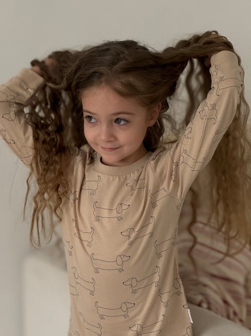 Free Portrait of a Little Girl with Long Curly Hair Stock Photo