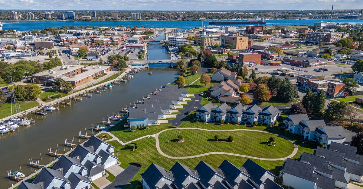 Stunning aerial view of Port Huron, Michigan featuring residential areas, waterways, and cityscape in summer.