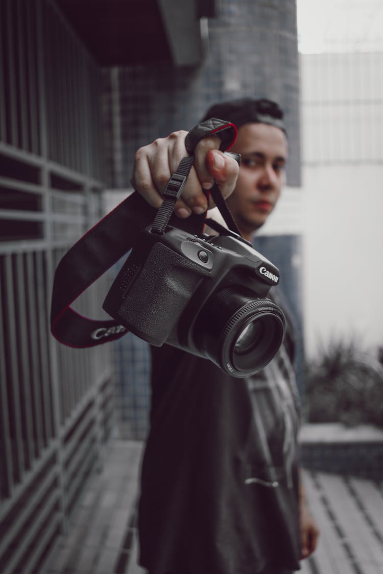 Person Holding Black Canon Camera