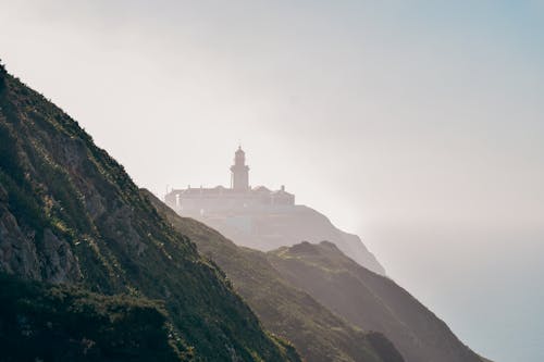 Silhouette of Cabo da Roca Lighthouse Hidden in the Fog Above the Ocean