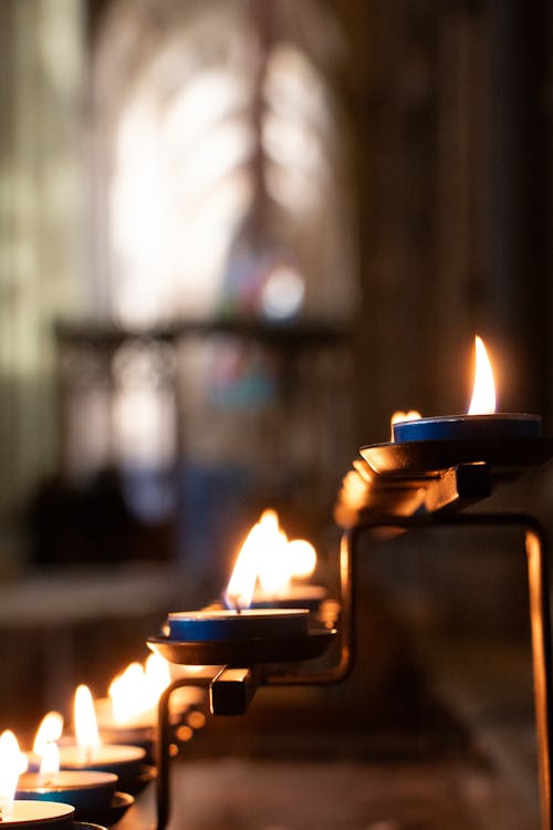 Close-up of Lit Candles in a Church 