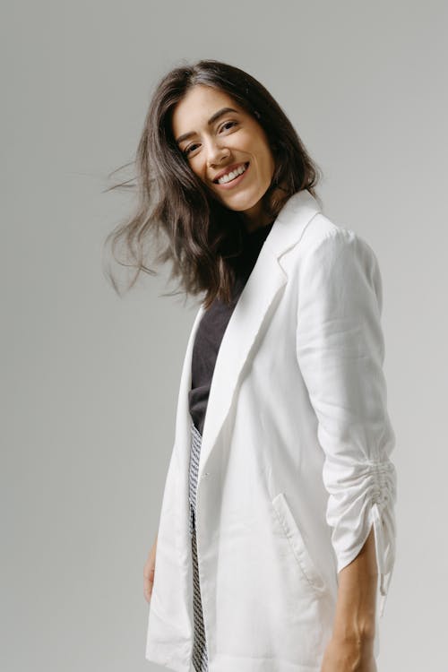 Free Studio Shot of a Young Brunette in a Fashionable Outfit  Stock Photo