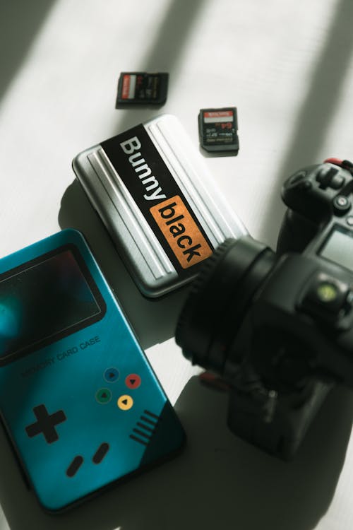 A camera, a gameboy and a camera lens