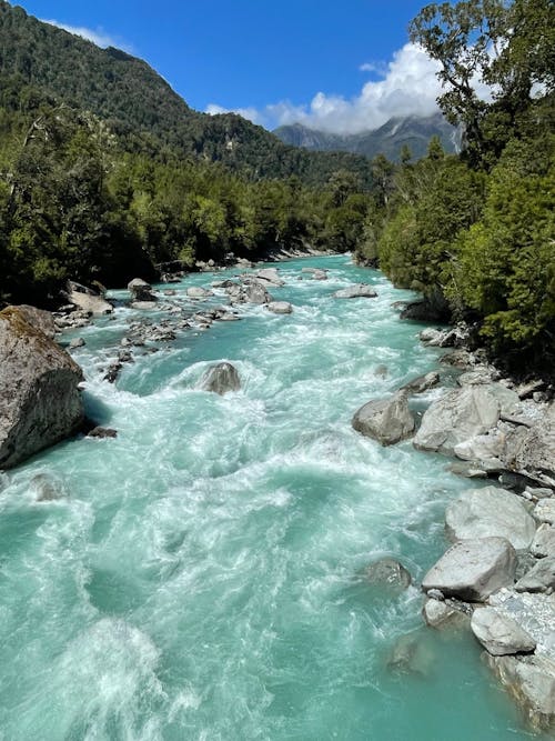 Free Landscape with Stones in a Turquoise River Stock Photo