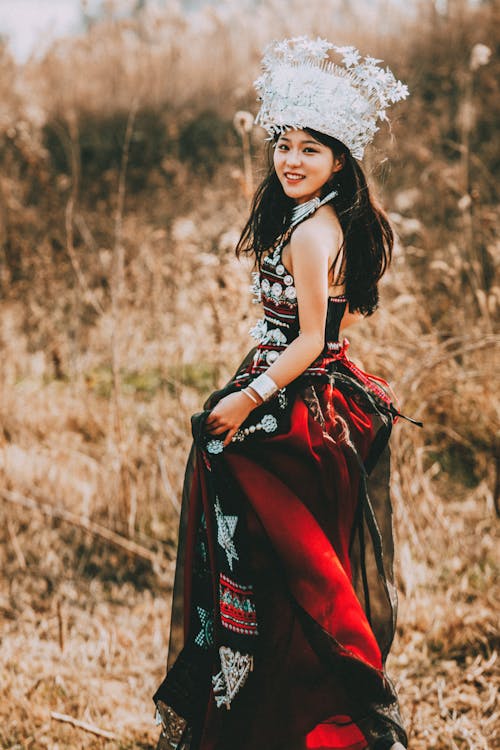 Smiling Woman in Crown and Traditional Clothing