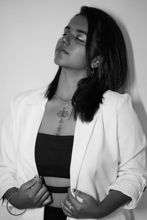 Young Woman with a Tattoo, Posing in a White Suit