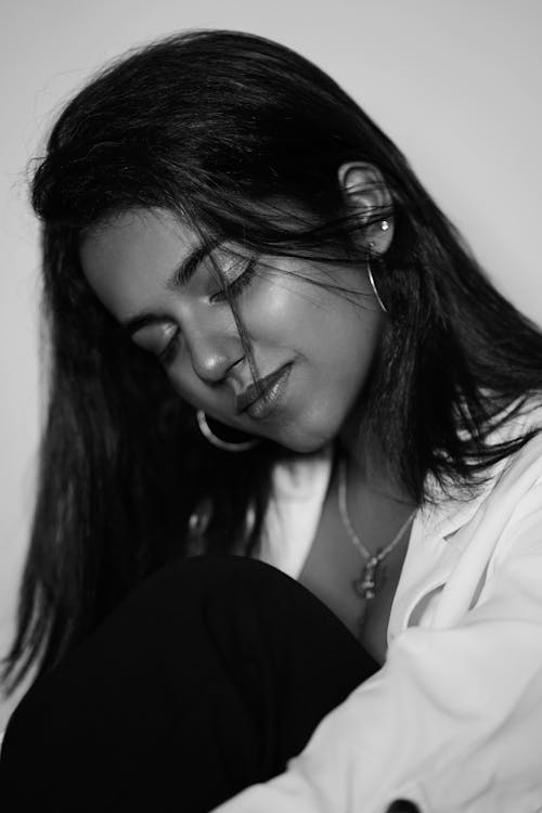 Black and White Photo of a Young Woman Sitting with Eyes Closed